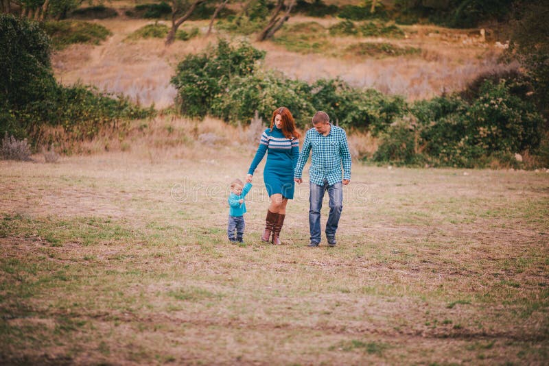 Happy Family in Blue Stylish Clothes Walking in Autumn Forest Stock ...