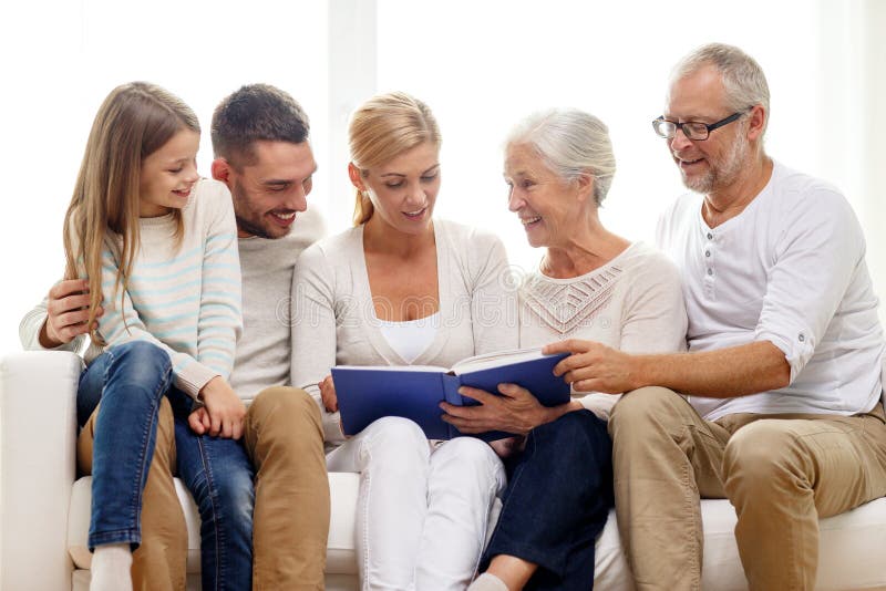 Happy family with book or photo album at home