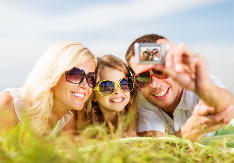 Happy family with camera taking picture