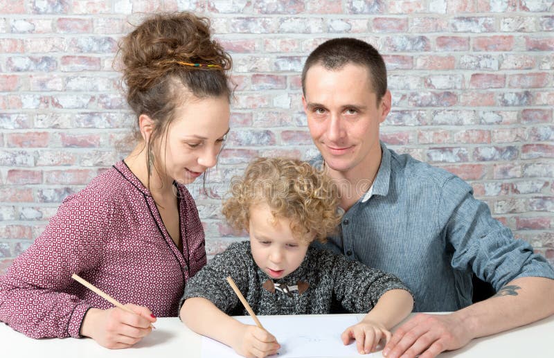 Happy family, child, father and mother drawing royalty free stock images Happy family, child, father and mother drawing royalty free stock images