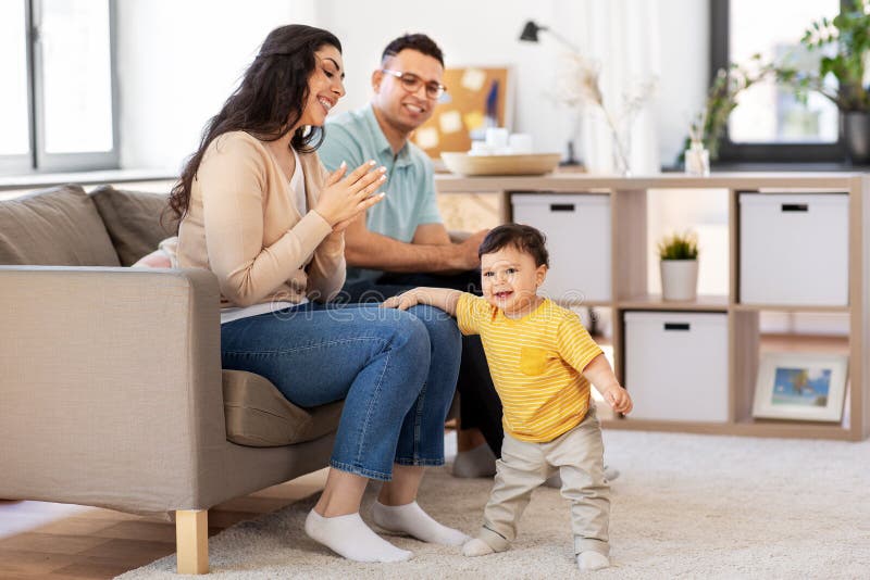 Happy family with child sitting on sofa at home