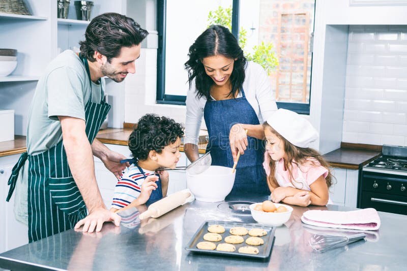 Happy family cooking biscuits together
