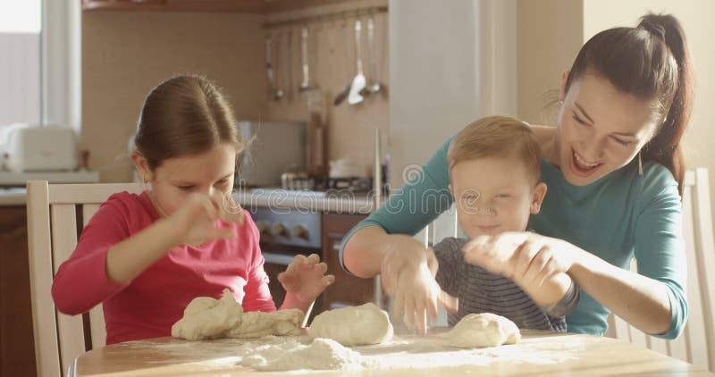 Happy Family Cooking in the Kitchen Playing with the Dough and Ingredients