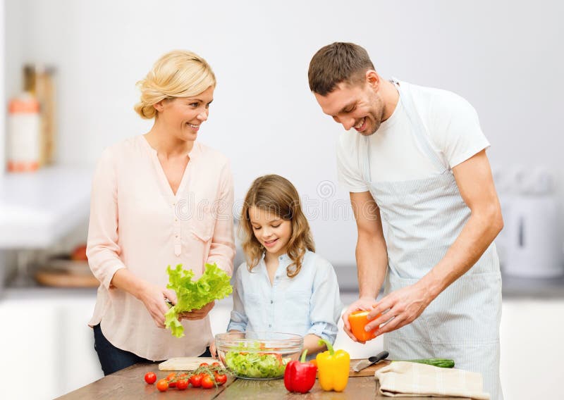 Happy family cooking vegetable salad for dinner royalty free stock photo Happy family cooking vegetable salad for dinner royalty free stock photo