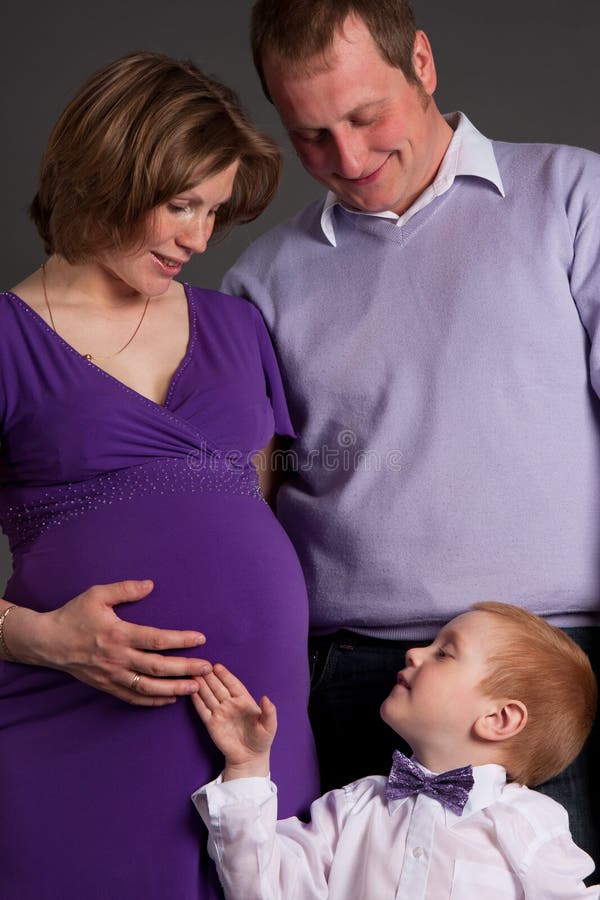 Happy family with cute boy expecting another baby