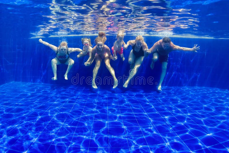 Happy family dive in swimming pool