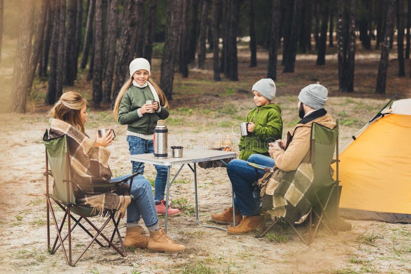 happy family drinking hot tea while having royalty free stock photography happy family drinking hot tea while having royalty free stock photography