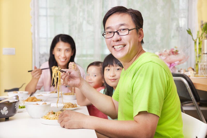 Happy Family Eating noodles at home