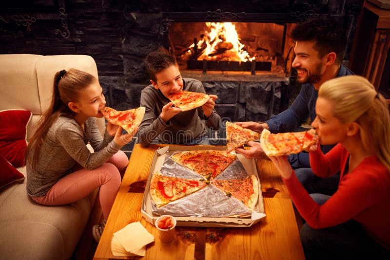 Happy family eating pizza slices for the dinner royalty free stock photo Happy family eating pizza slices for the dinner royalty free stock photo