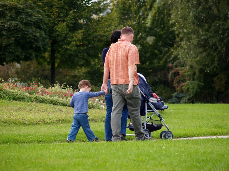 Famiglia, padre,madre e due figli, di godere di domenica pomeriggio a passeggio nel parco