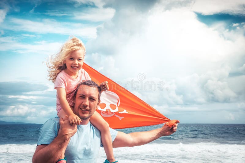 Happy family father and child daughter on his shoulders against blue sky and sea royalty free stock images