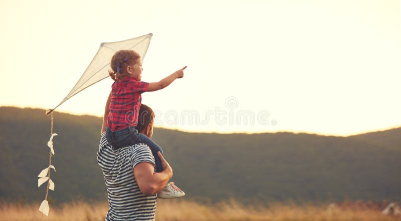 Happy family father and child on meadow with a kite in summer stock photo Happy family father and child on meadow with a kite in summer stock photo