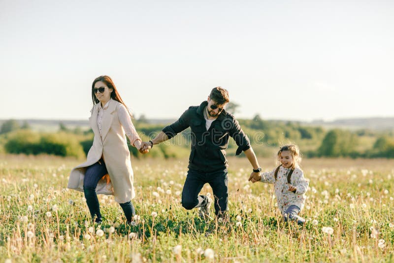 Happy family father, mother and child daughter on nature at sunset royalty free stock photography Happy family father, mother and child daughter on nature at sunset royalty free stock photography