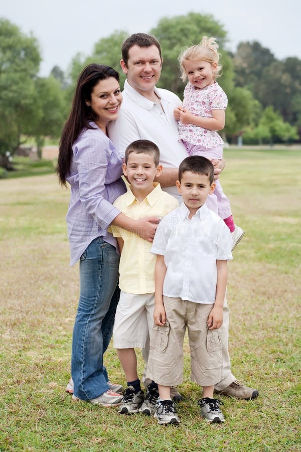 Happy Family Of Five Posing On Natural Background Stock Photo - Image