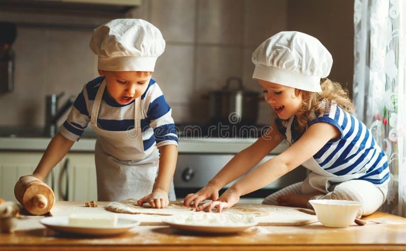 Happy family funny kids bake cookies in kitchen