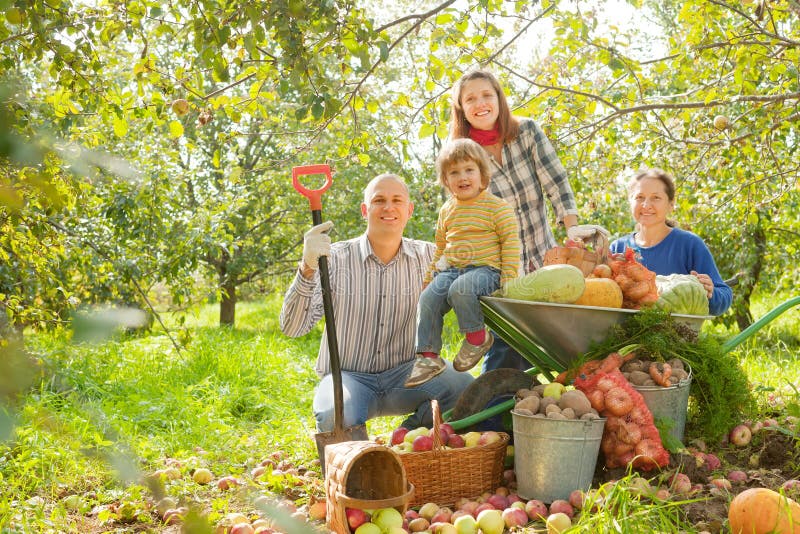 Happy family with harvest in garden