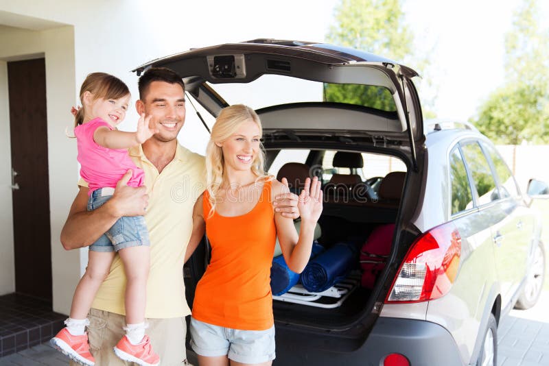 Happy family with hatchback car at home parking