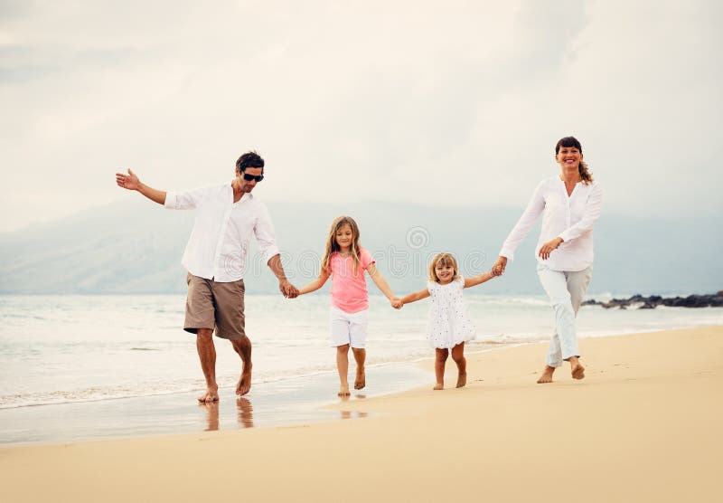 Happy Family have Fun Walking on Beach at Sunset