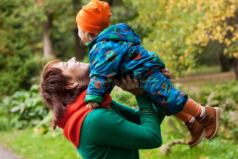 Happy family having fun in autumn park