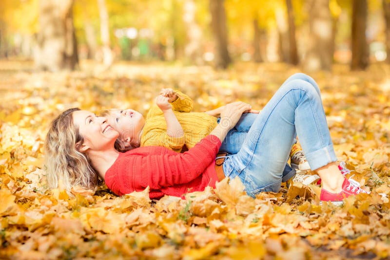 Happy family having fun outdoor in autumn park stock photo Happy family having fun outdoor in autumn park stock photo