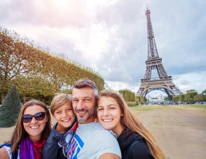 Happy family having fun together in Paris near the Eiffel tower