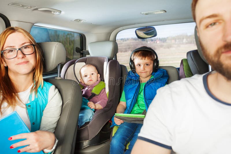 Happy family having fun travelling by car