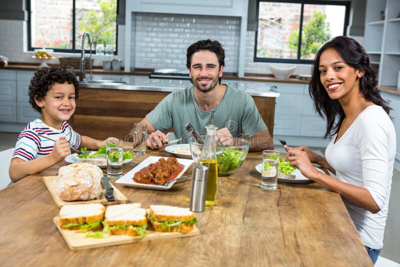 Happy Family Having Lunch Together Stock Image - Image of house, girl