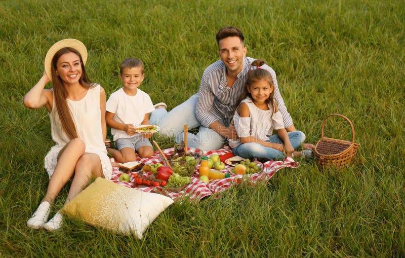 Happy family having picnic in park royalty free stock photos Happy family having picnic in park royalty free stock photos