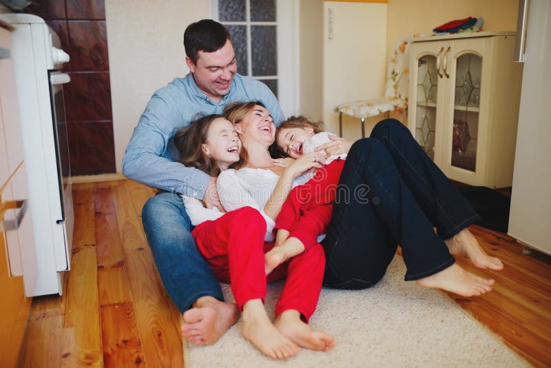 Happy family at home on the floor