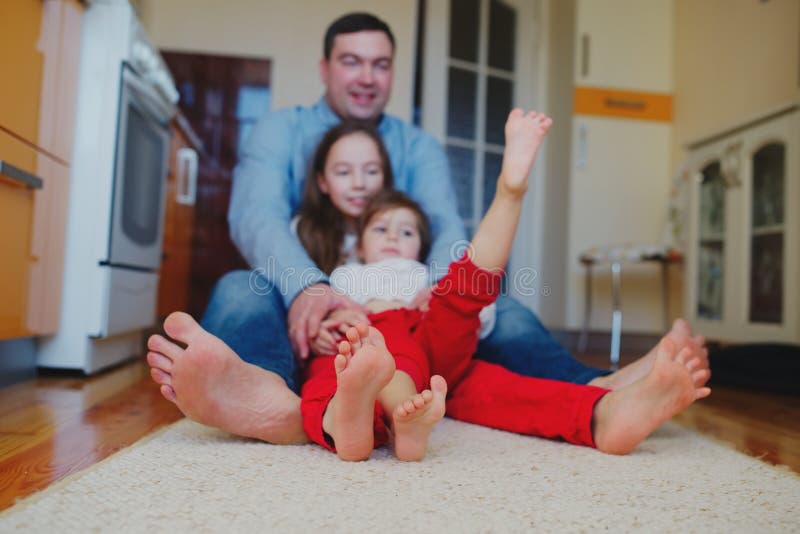 Happy family at home on the floor