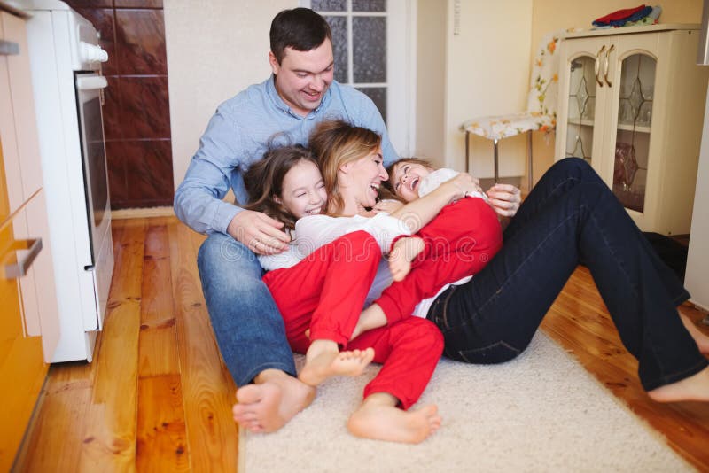 Happy family at home on the floor