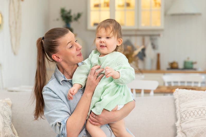 Happy Family at Home. Mother Lifting in Air Little Toddler Child ...