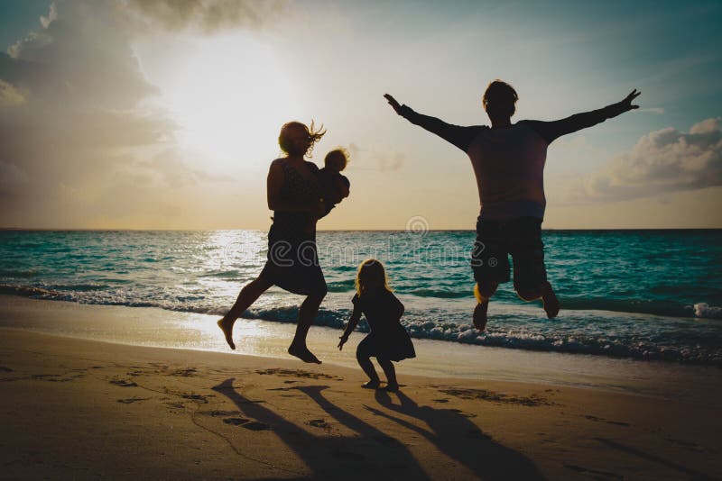 Happy family with kids on enjoy vacation, play on sunset beach royalty free stock photography Happy family with kids on enjoy vacation, play on sunset beach royalty free stock photography