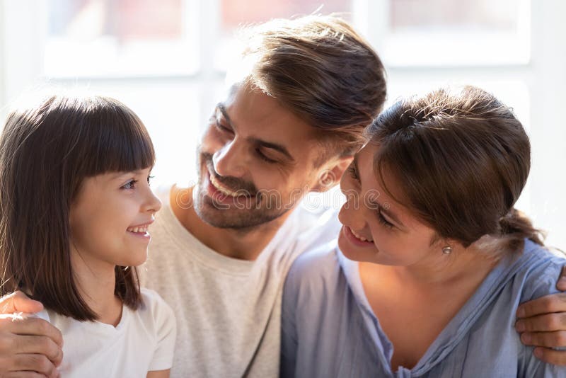 Happy family with little daughter hug enjoy time together