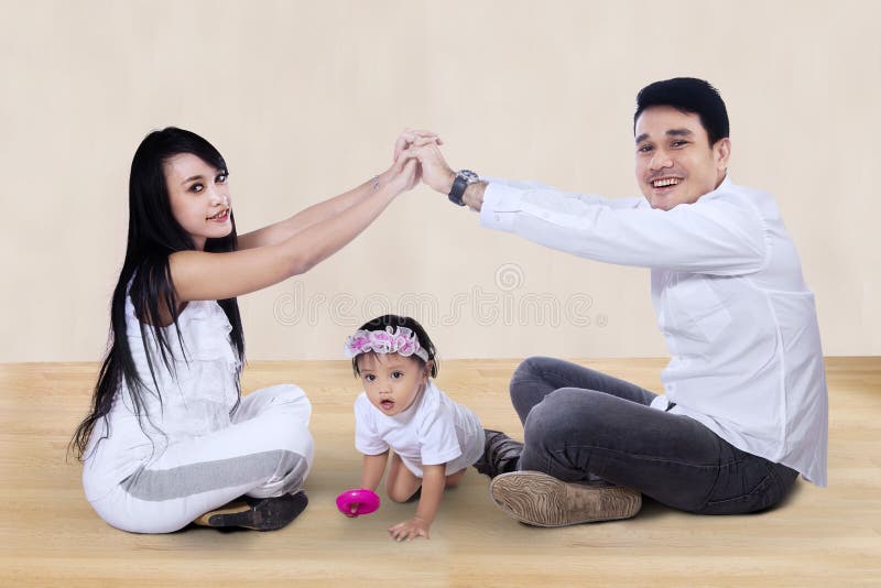 Young happy asian family making the home sign at home. Young happy asian family making the home sign at home