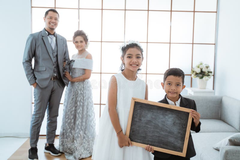 Portrait of a Happy Family with Modern Clothes Holding Blackboard. Family Photo Concept Stock Photo - Image of dress, couple: 201494504 Portrait Of A Happy Family With Modern Clothes Holding Blackboard. Family Photo Concept Stock Photo - Image Of Dress, Couple: 201494504