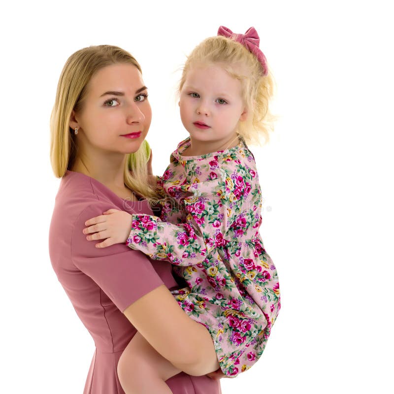 Mom and little daughter studio portrait on a white background.