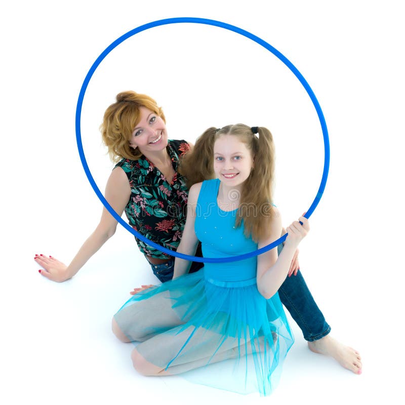 Mom and little daughter studio portrait on a white background.