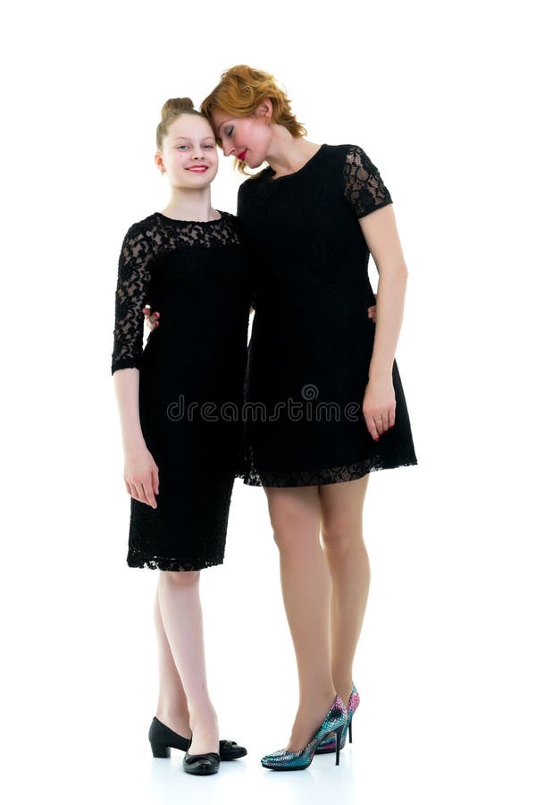 Mom and little daughter studio portrait on a white background.