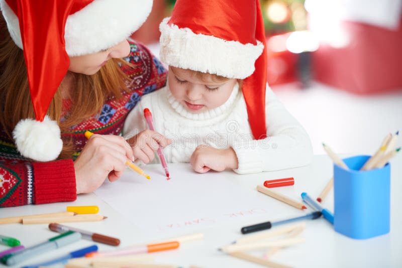 Happy family mother and child daughter write aletter to Santa o. Claus, baby.