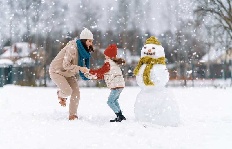 Mother and child girl on a winter walk