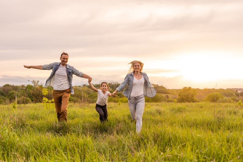 Happy Family: Mother Father and Child Daughter on Nature on Sunset ...