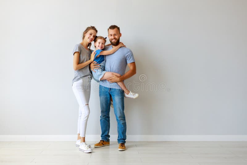 Happy family mother father and child near an empty wall royalty free stock image Happy family mother father and child near an empty wall royalty free stock image