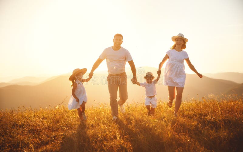 Happy family: mother, father, children son and daughter on sunset stock images Happy family: mother, father, children son and daughter on sunset stock images