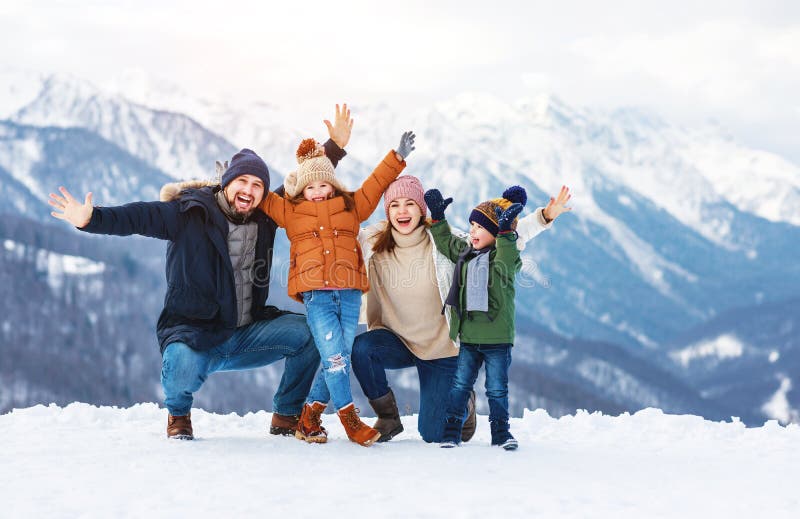 Happy family mother father and children on winter nature