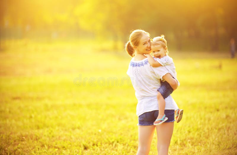 Happy family on nature mother and baby daughter