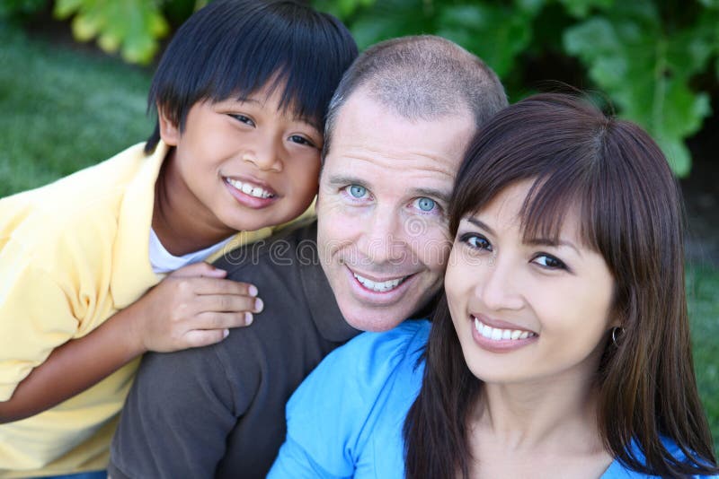 Attractive happy family having fun in the park. Attractive happy family having fun in the park