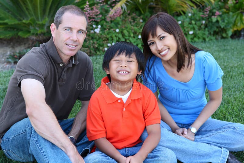 Attractive happy family having fun in the park. Attractive happy family having fun in the park