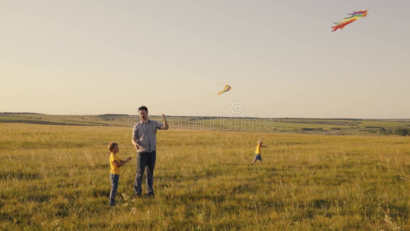 Happy family park Father and sons in the park launch flying kite into sky Childhood dream fly Boys child with dad play