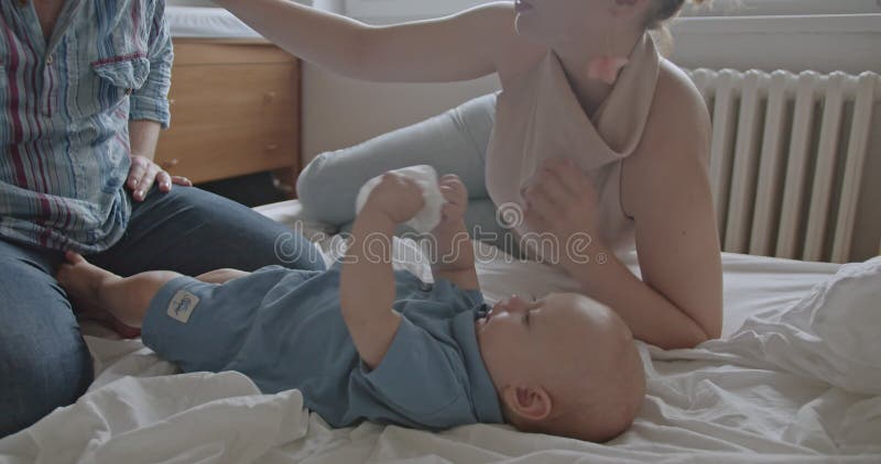 Happy Family Playing with the Baby Boy on a Bed in the Dormitor at Home stock footage